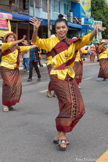 woman in Thai traditional clothes dancing in the parade