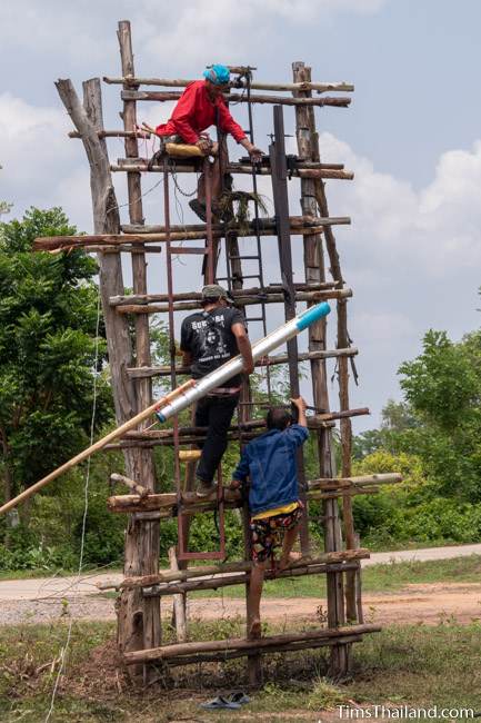 men putting rocket on launch pad