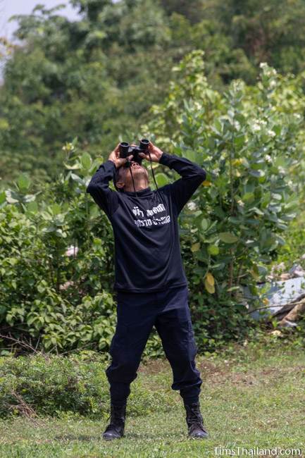 man looking through binoculars