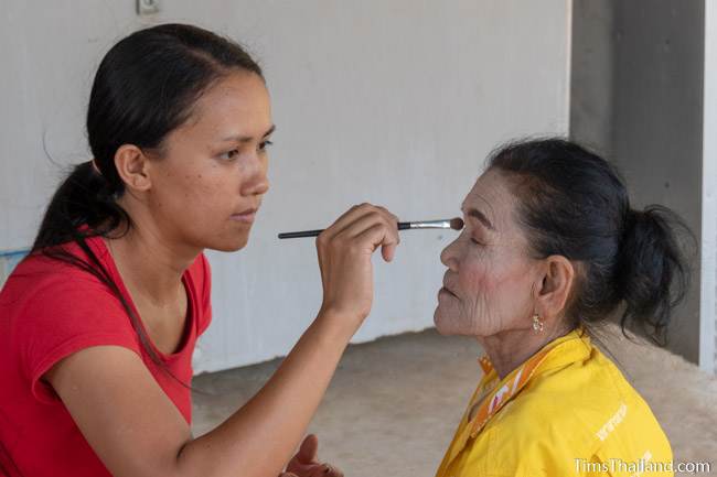 woman doing another woman's makeup