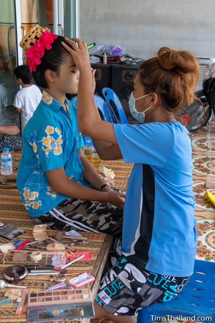 woman doing another woman's makeup