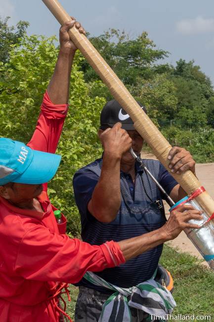 men making hole in rocket's gunpowder