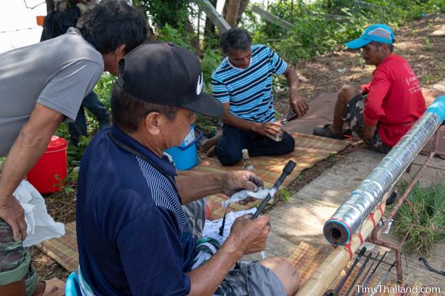 men making hole in rocket's gunpowder