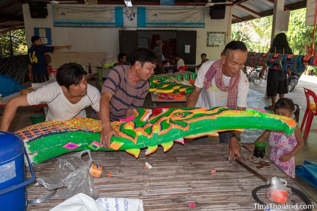 men lifting naga head