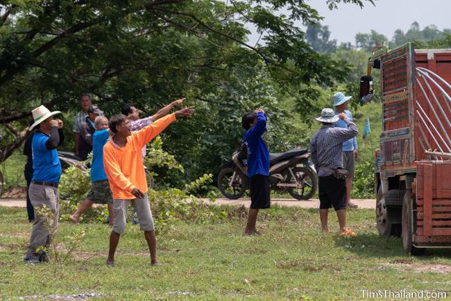 men pointing at the sky