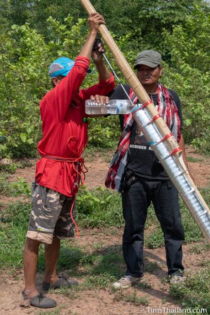 man pouring water into a rocket