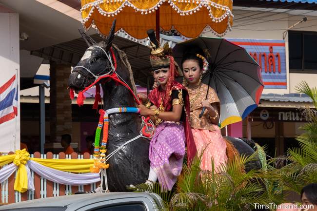 parade float with kids riding a fake horse in the parade