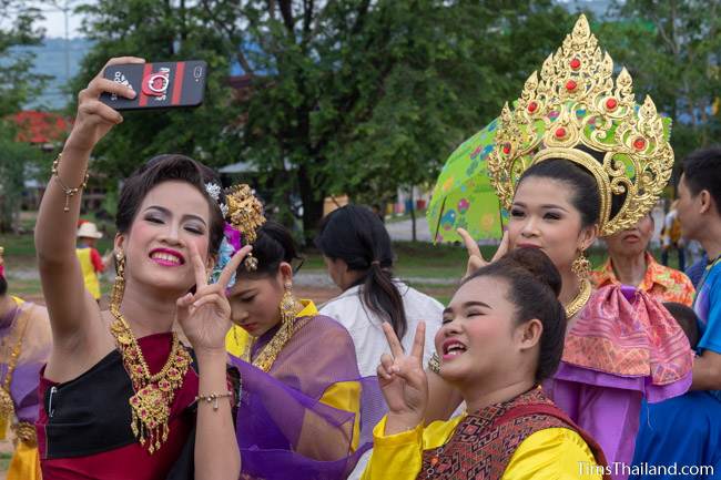 women in traditional Thai clothes taking a selfie