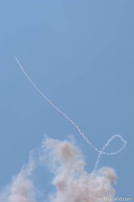 smoke trail from a rocket looping through the sky