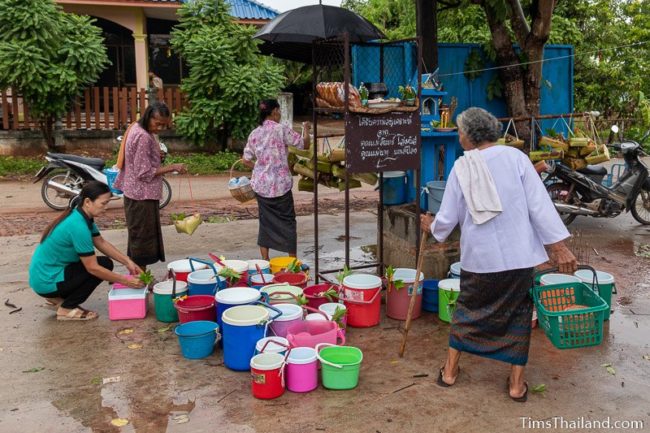 women delivering kratong and water buckets