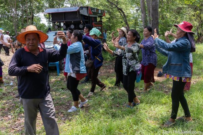 people dancing in front of truck with large PA system