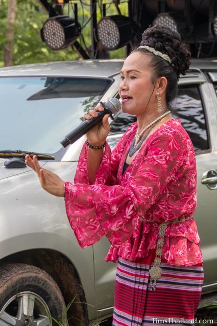 woman singing in front of truck with large PA system