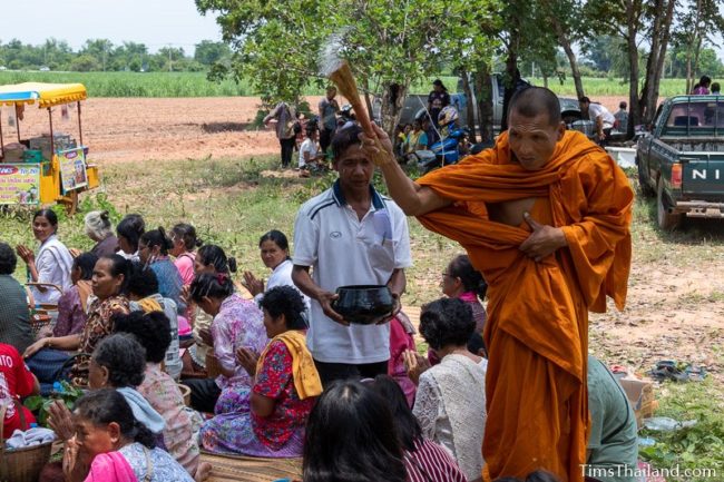 monk splashing water