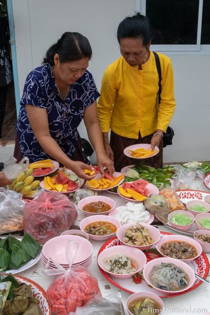 women preparing food trays