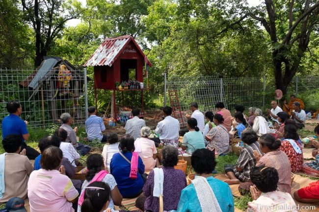 women sitting in front of shrine