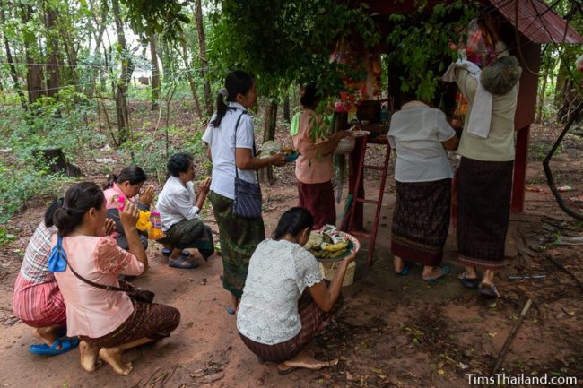 women bringing food to shrine