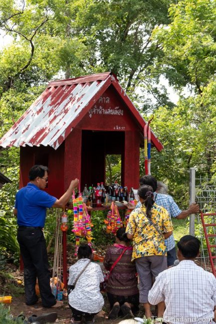 men and women taking food to the shrine