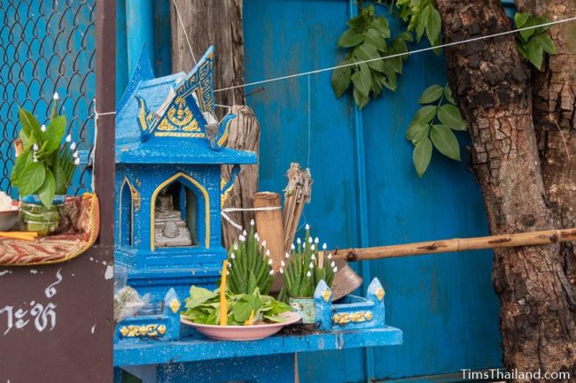 white string tied to a blue Buddha shrine