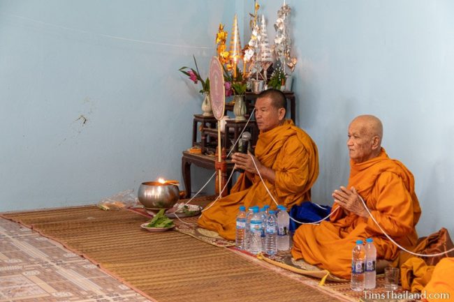 monks holding white string