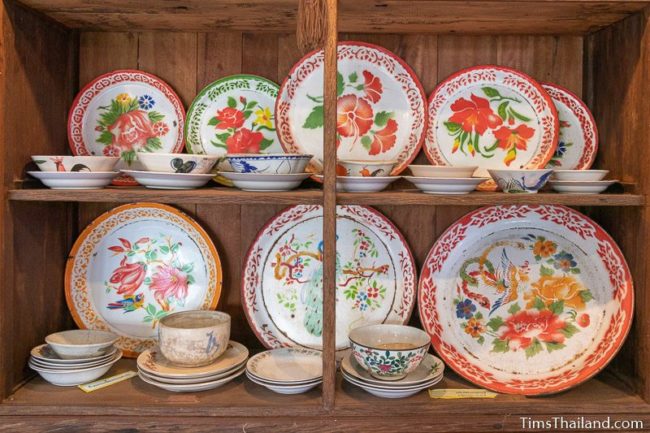 two shelves full of colorful serving trays