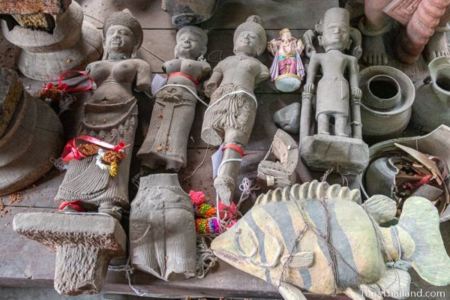 five broken Khmer statues