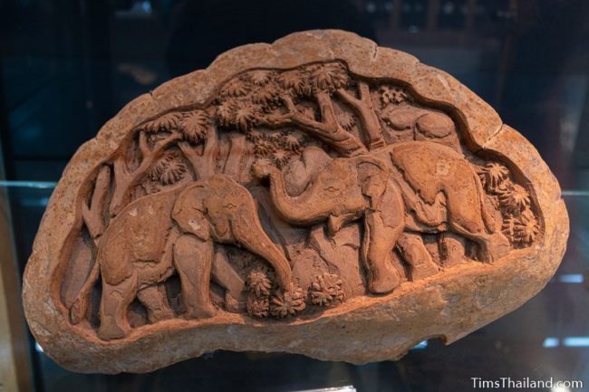 elephants carved onto a large mushroom