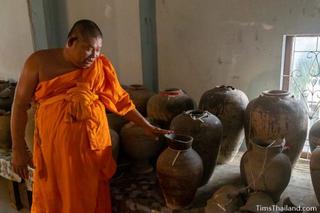 monk showing Khmer pottery