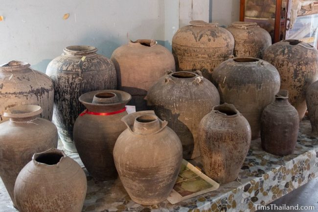 rows of old pots on a table.