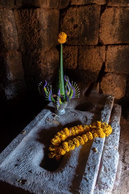 three-holed pedestal with flowers on top