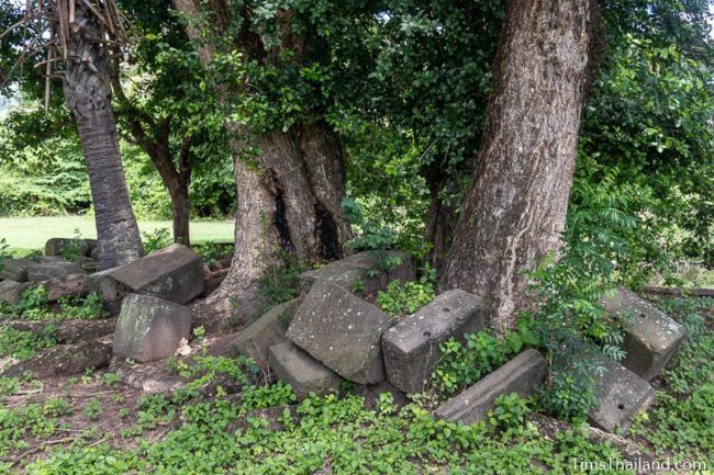 pile of sandstone blocks under trees