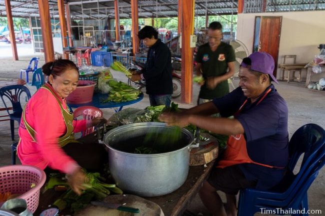 people cutting vegetables