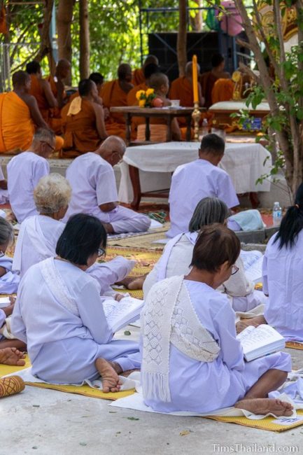 monks and people in white chanting