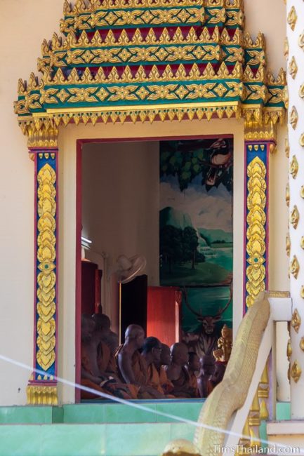 view of monks sitting in the ubosot