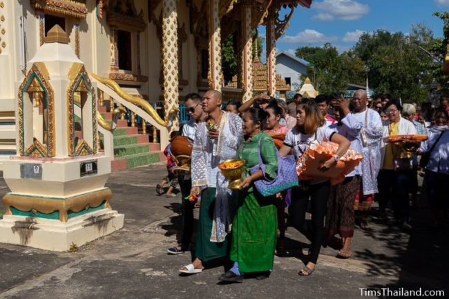 people walking around the ubosot