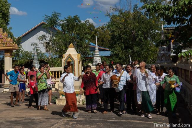 people walking around the ubosot