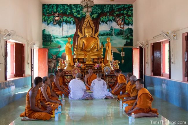 monks and men about to become monks inside the ubosot