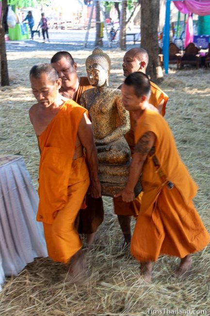 monks carrying a Buddha statue