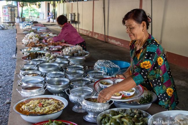 women putting food on a table