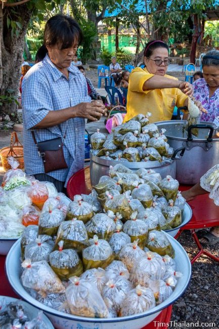 women putting food in bags