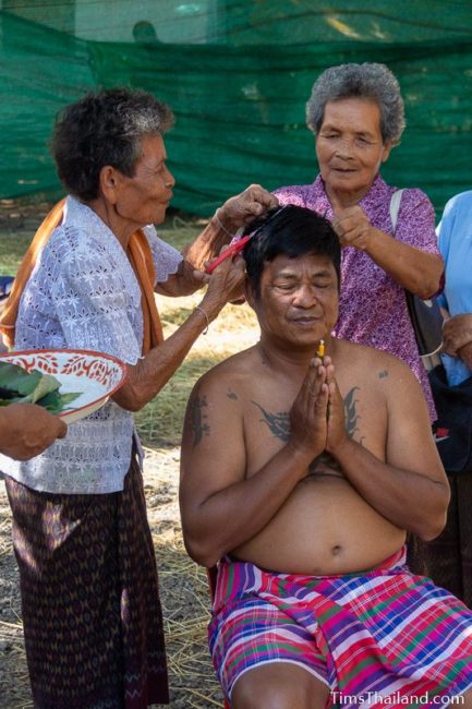 women cutting a man's hair