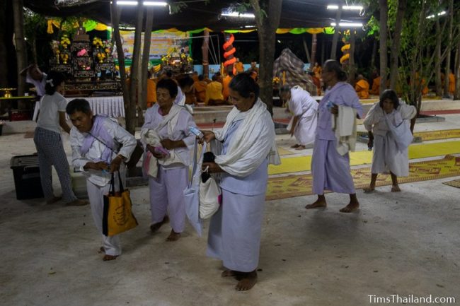 women in white getting up and leaving