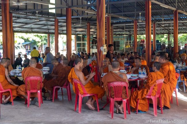 monks eating at tables