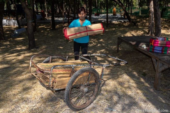 woman putting sitting mats in a cart