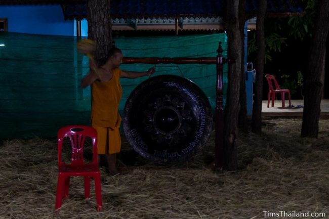 man hitting a gong