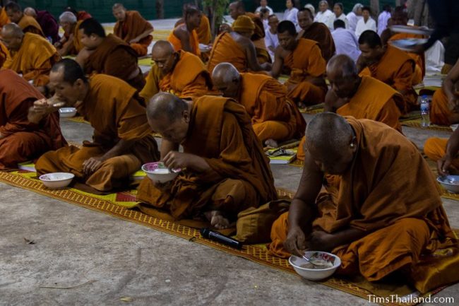 monks eating rice porridge