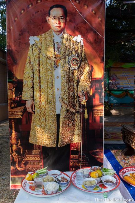 food offering in front of a picture of King Rama 9