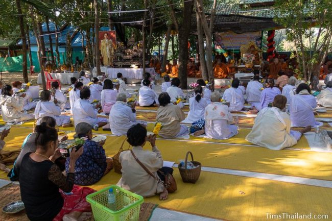 monks and people in white chanting