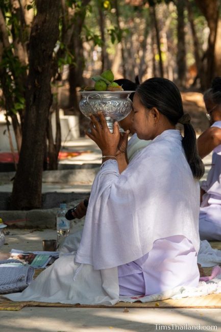 woman in white holding flowers