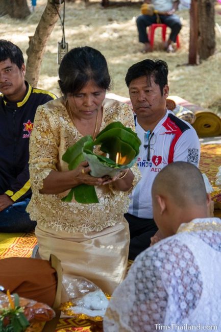 man who will become a monk sitting in a ceremony