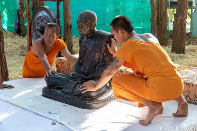 monks moving a monk statue